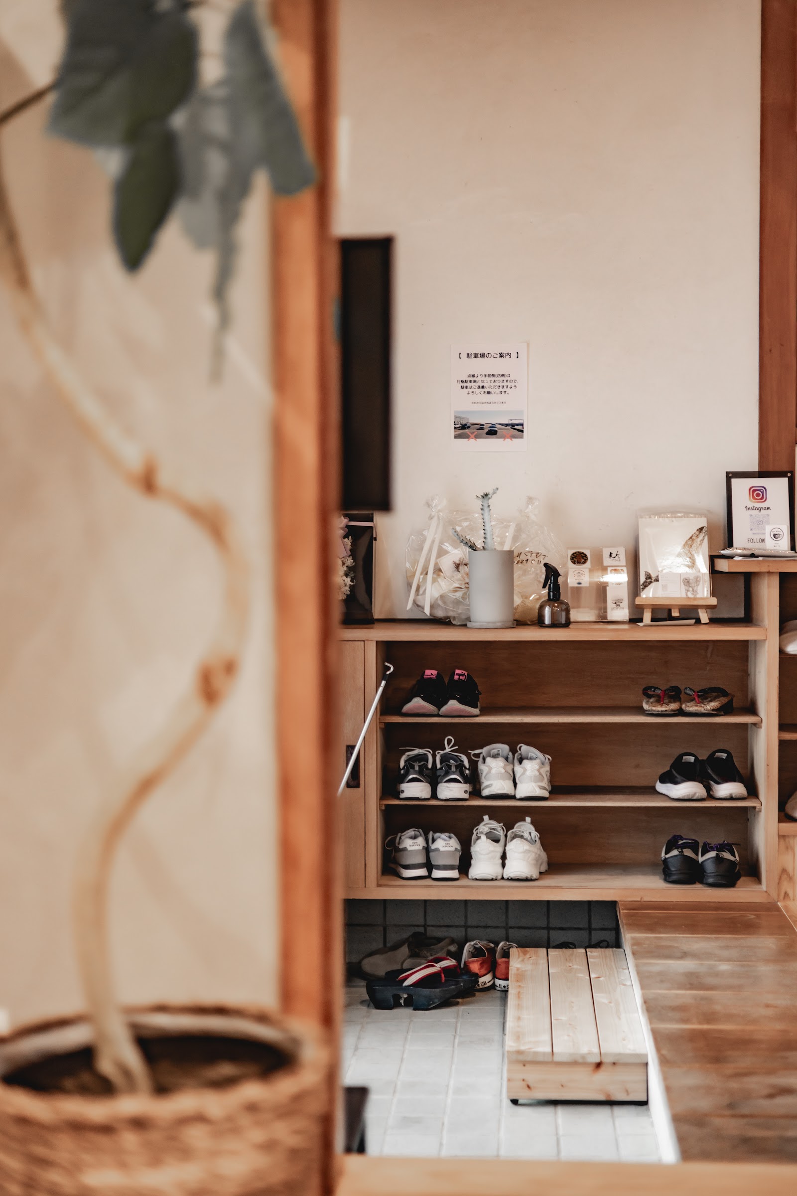 Genkan entrance with guests' shoes on the wooden shelf