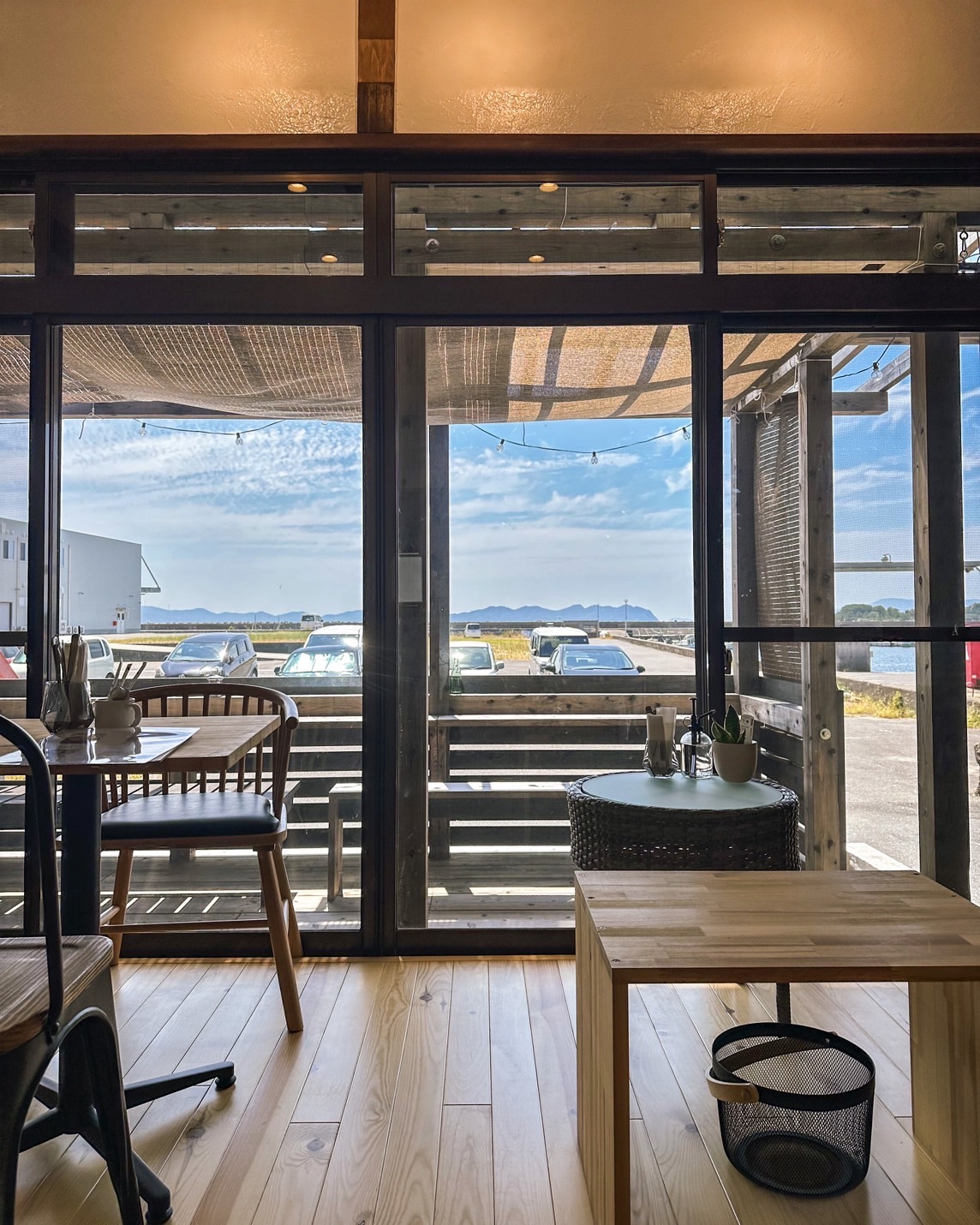 View through the glass doors past the deck to Murozumi harbor